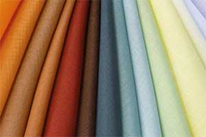 A range of colourful Silent Gliss fabrics laid out.